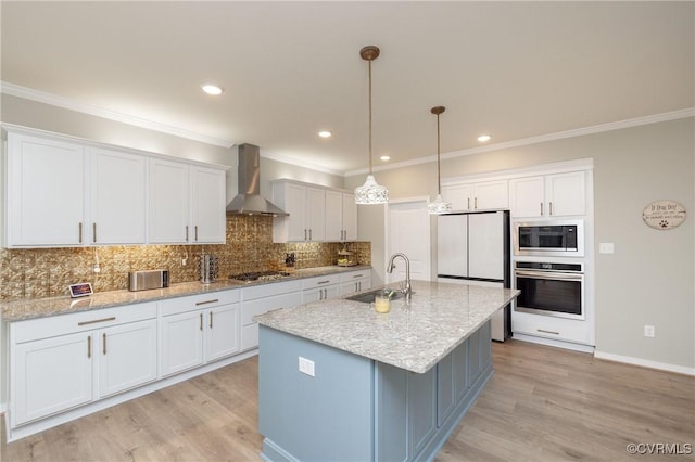 7324 Bailie Dr, Mechanicsville, VA 23111 - kitchen with a sink, appliances with stainless steel finishes, light wood-style flooring, wall chimney range hood, and decorative backsplash