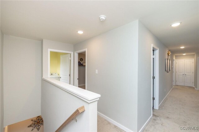 7324 Bailie Dr, Mechanicsville, VA 23111 - hallway featuring light colored carpet, washer / dryer, an upstairs landing, and baseboards