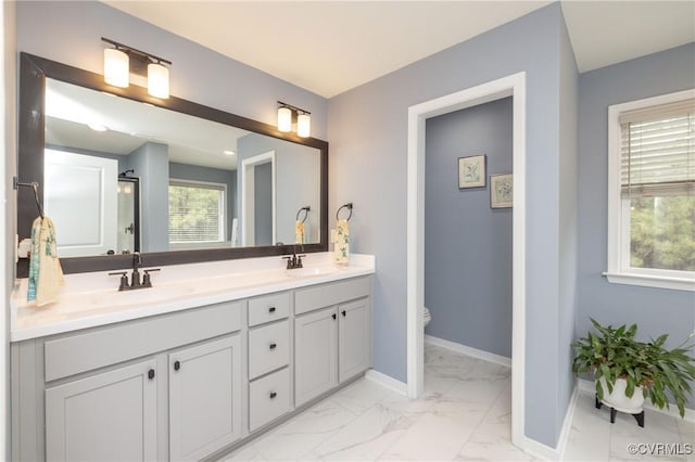 7324 Bailie Dr, Mechanicsville, VA 23111 - full bathroom with marble finish floor, baseboards, double vanity, and a sink