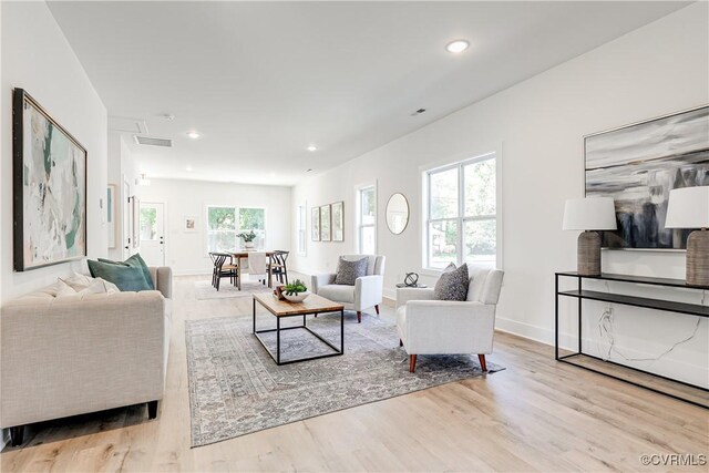 8031 Lake Shore Dr, North Chesterfield, VA 23235 - living area with wood finished floors, a wealth of natural light, recessed lighting, and visible vents
