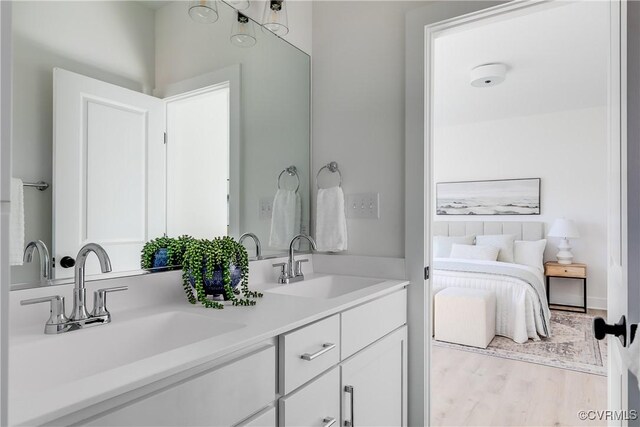 8031 Lake Shore Dr, North Chesterfield, VA 23235 - full bathroom with double vanity, a sink, and wood finished floors