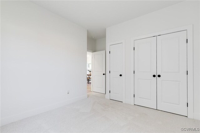 8031 Lake Shore Dr, North Chesterfield, VA 23235 - unfurnished bedroom with baseboards, multiple closets, and carpet flooring