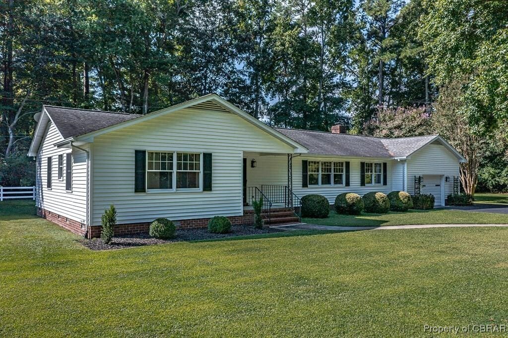35 Powhatan Rd, Kilmarnock, VA 22482 - single story home with a chimney, a front lawn, a shingled roof, crawl space, and a garage