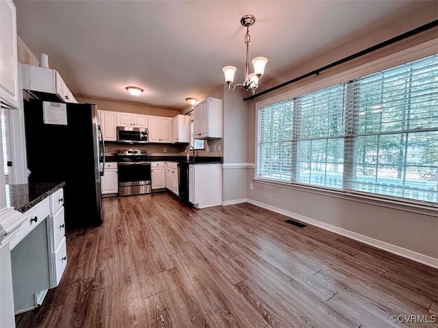 14312 Ashdale Way, Chesterfield, VA 23832 - kitchen with appliances with stainless steel finishes, dark countertops, a chandelier, and a sink