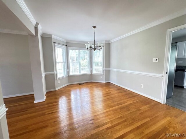 14312 Ashdale Way, Chesterfield, VA 23832 - empty room with a chandelier, wood finished floors, and ornamental molding