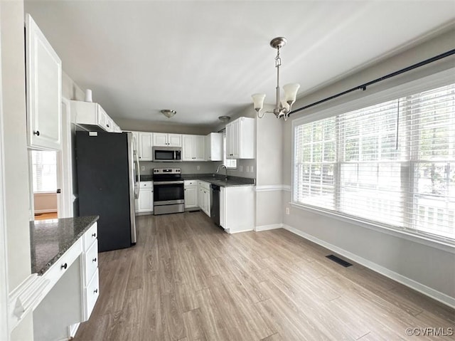14312 Ashdale Way, Chesterfield, VA 23832 - kitchen featuring appliances with stainless steel finishes, a chandelier, white cabinets, and wood finished floors