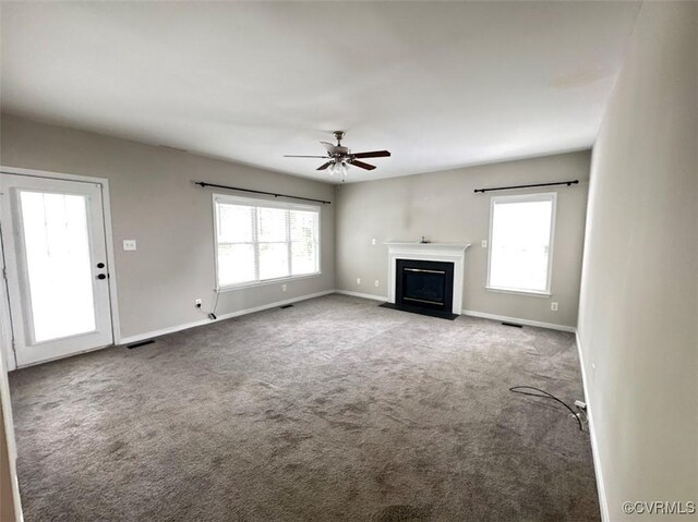 14312 Ashdale Way, Chesterfield, VA 23832 - unfurnished living room featuring healthy amount of natural light, carpet, a ceiling fan, and a fireplace with flush hearth