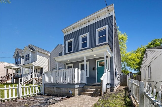view of front of house featuring covered porch and fence private yard