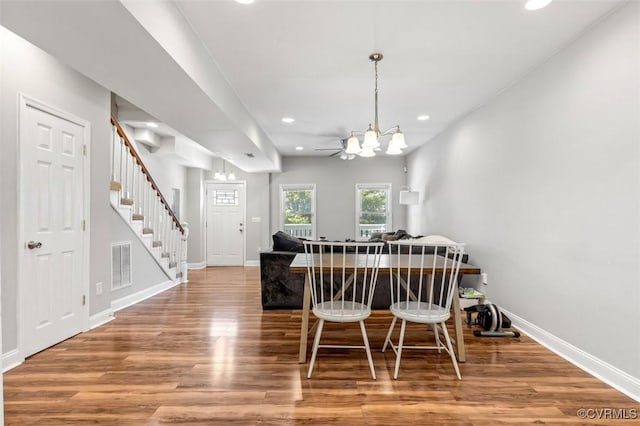 dining area with visible vents, recessed lighting, wood finished floors, and stairway