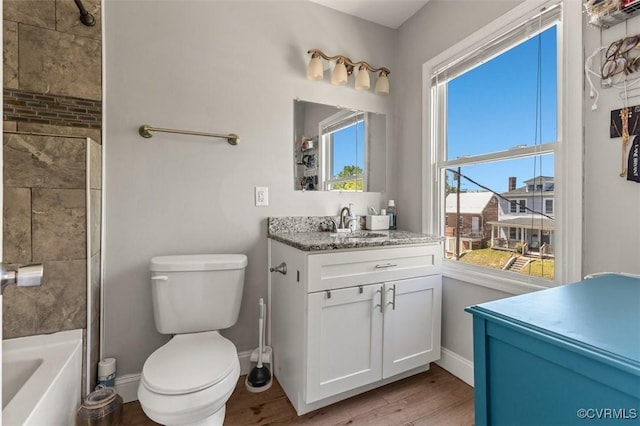 bathroom featuring vanity, baseboards, toilet, and wood finished floors