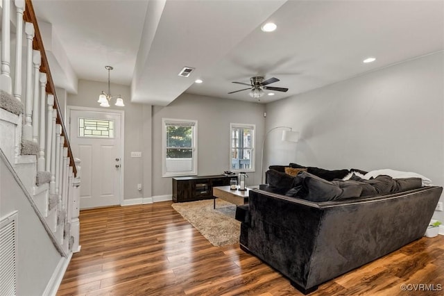 living room with recessed lighting, baseboards, wood finished floors, and ceiling fan with notable chandelier