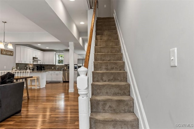 stairs featuring baseboards, recessed lighting, and wood finished floors