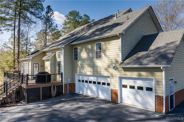 13494 Lakeview Farms Pl, Ashland, VA 23005 - view of property exterior featuring brick siding, driveway, a shingled roof, and a deck