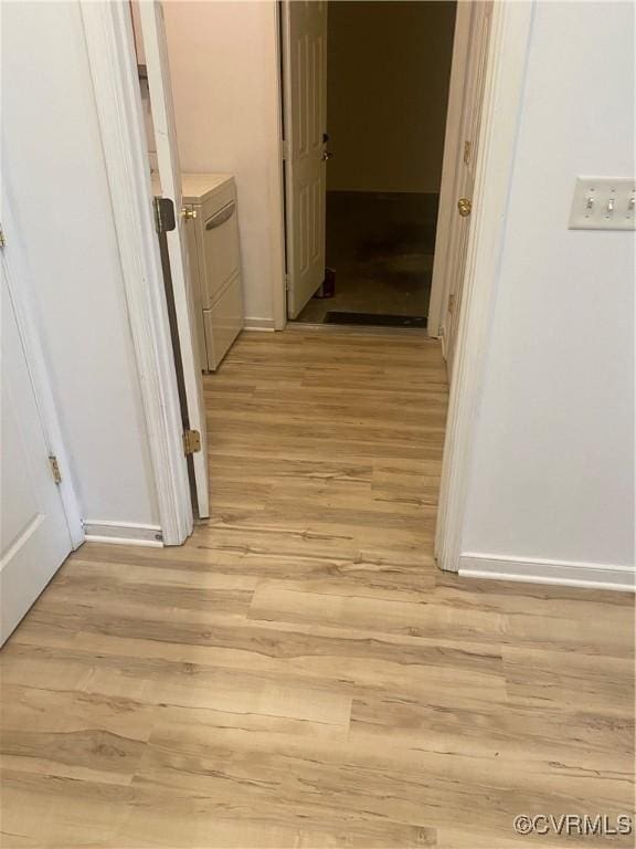 2404 Wanstead Ct, Henrico, VA 23238 - hall featuring washing machine and clothes dryer, light wood finished floors, and baseboards
