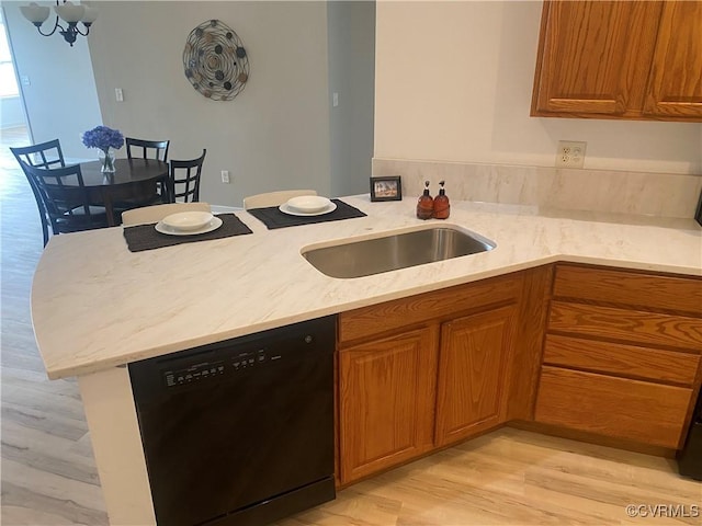 2404 Wanstead Ct, Henrico, VA 23238 - kitchen with dishwasher, a chandelier, a peninsula, light wood finished floors, and brown cabinets