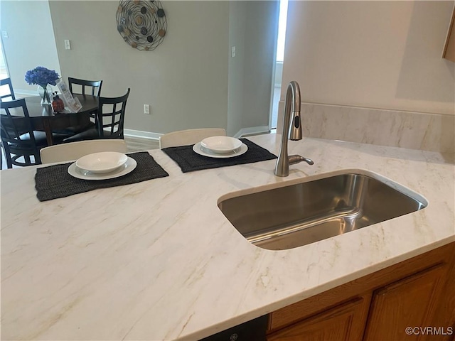 2404 Wanstead Ct, Henrico, VA 23238 - kitchen featuring a sink, brown cabinetry, and light stone countertops