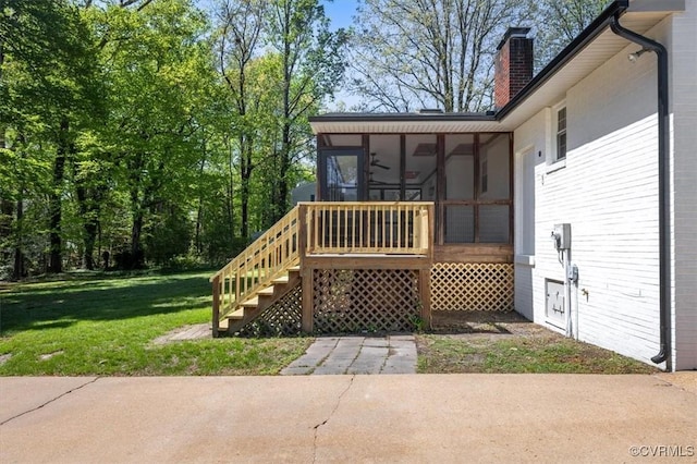 wooden terrace with a sunroom, stairway, and a lawn