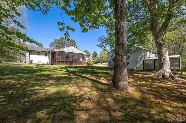 view of yard with an outdoor structure and a sunroom