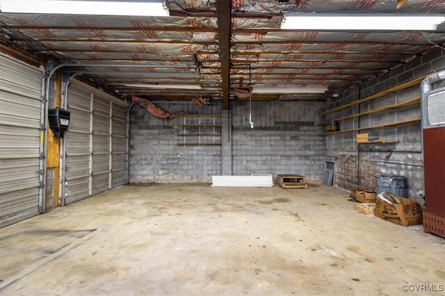 garage with concrete block wall