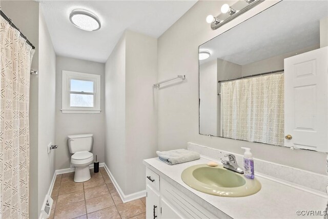 2407 Crawley Rd, Cullen, VA 23924 - bathroom featuring tile patterned flooring, vanity, toilet, baseboards, and visible vents