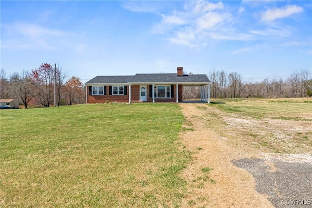 2407 Crawley Rd, Cullen, VA 23924 - view of front of house with dirt driveway, a front lawn, brick siding, a carport, and a chimney
