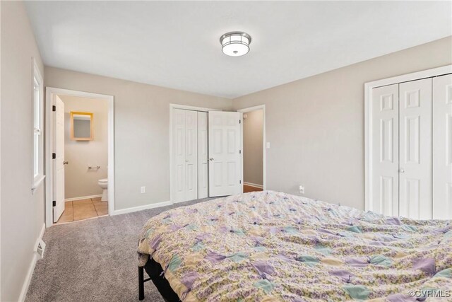 2407 Crawley Rd, Cullen, VA 23924 - bedroom with carpet floors, connected bathroom, baseboards, and multiple closets