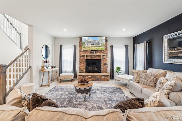 living area with recessed lighting, plenty of natural light, and stairs