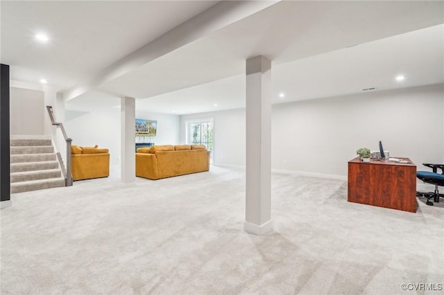below grade area featuring baseboards, light carpet, stairs, and recessed lighting