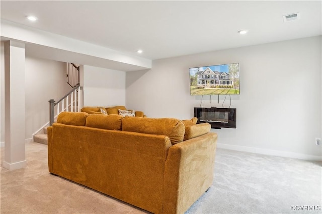 living area with light colored carpet, baseboards, stairs, and visible vents