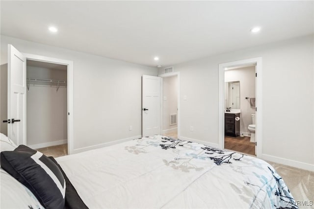 bedroom featuring recessed lighting, visible vents, and ensuite bathroom
