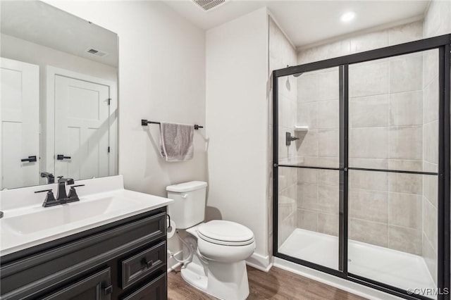 full bath with wood finished floors, visible vents, toilet, and a stall shower