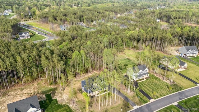 drone / aerial view with a wooded view