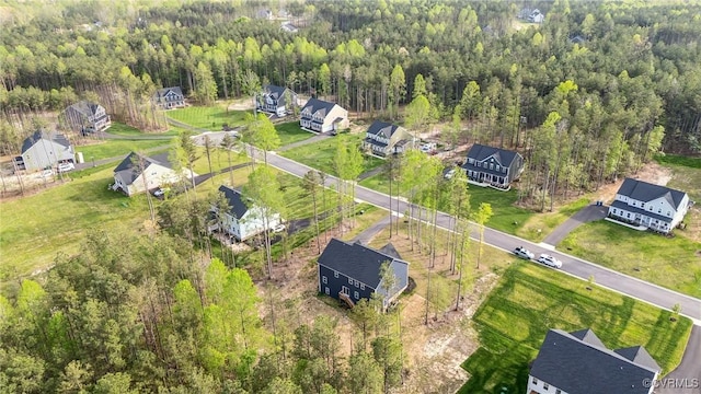 birds eye view of property with a residential view and a wooded view