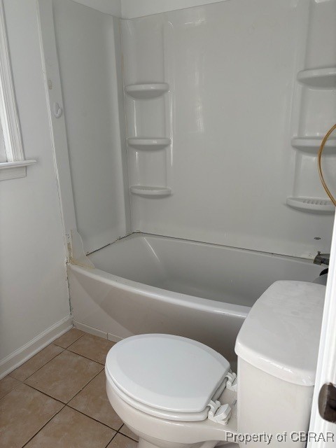 full bath with tile patterned floors, toilet, bathtub / shower combination, and baseboards