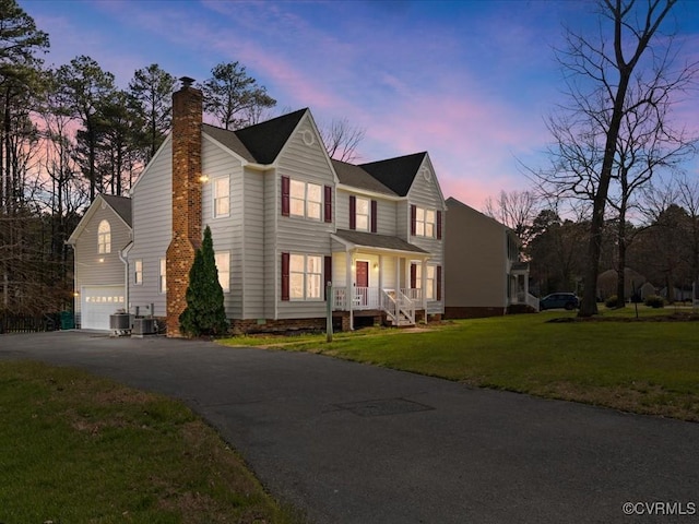 10107 Heritage Ln, Glen Allen, VA 23060 - view of front of property featuring a chimney, driveway, a garage, a front lawn, and a porch