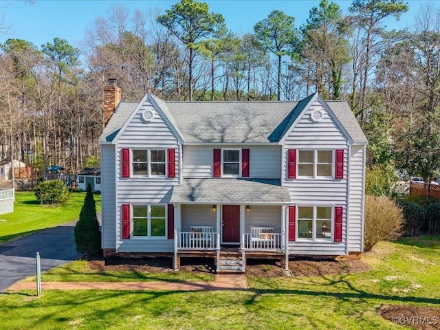 10107 Heritage Ln, Glen Allen, VA 23060 - traditional-style home featuring a porch, roof with shingles, a chimney, a front yard, and driveway