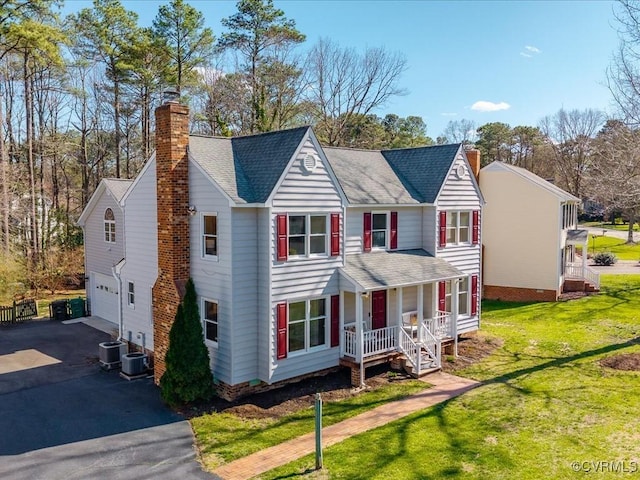 10107 Heritage Ln, Glen Allen, VA 23060 - view of front of property featuring a chimney, a porch, driveway, and a garage