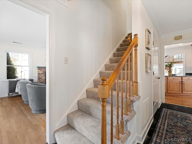10107 Heritage Ln, Glen Allen, VA 23060 - stairs featuring crown molding and wood finished floors