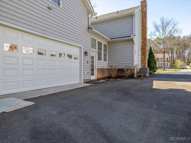 10107 Heritage Ln, Glen Allen, VA 23060 - view of home's exterior featuring asphalt driveway, a chimney, and a garage