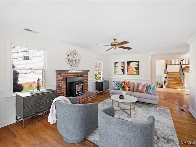 10107 Heritage Ln, Glen Allen, VA 23060 - living room with ornamental molding, stairs, a wood stove, wood finished floors, and ceiling fan