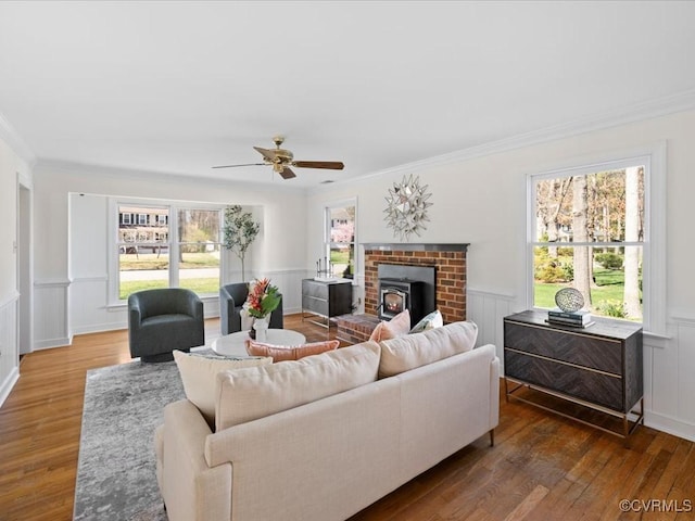 10107 Heritage Ln, Glen Allen, VA 23060 - living area with wood finished floors, a wainscoted wall, crown molding, a ceiling fan, and a decorative wall
