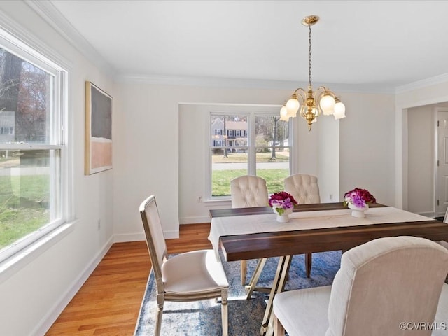 10107 Heritage Ln, Glen Allen, VA 23060 - dining area with healthy amount of natural light, a chandelier, light wood-style floors, and ornamental molding