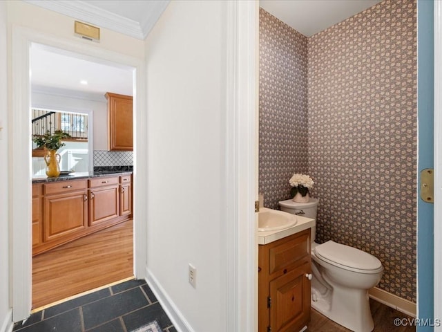 10107 Heritage Ln, Glen Allen, VA 23060 - bathroom featuring vanity, crown molding, backsplash, wallpapered walls, and tile patterned floors