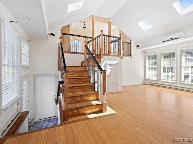 10107 Heritage Ln, Glen Allen, VA 23060 - stairway with a skylight, a wall mounted air conditioner, a baseboard radiator, plenty of natural light, and high vaulted ceiling