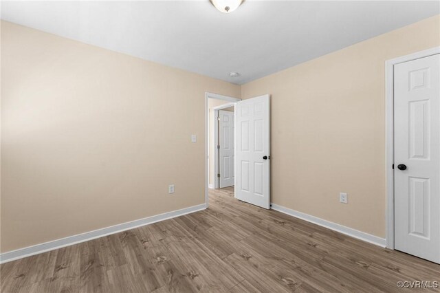 1713 Boydton Plank Rd, Petersburg, VA 23805 - unfurnished bedroom with baseboards and wood finished floors