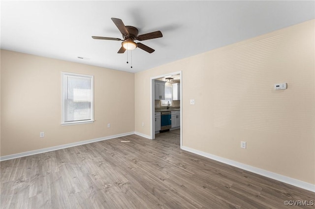 1713 Boydton Plank Rd, Petersburg, VA 23805 - unfurnished room featuring baseboards, ceiling fan, wood finished floors, and a sink