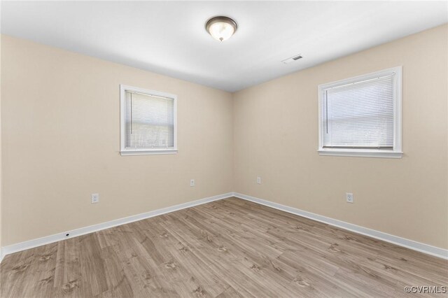 1713 Boydton Plank Rd, Petersburg, VA 23805 - empty room featuring a wealth of natural light, baseboards, light wood finished floors, and visible vents