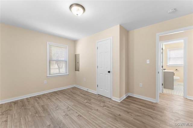 1713 Boydton Plank Rd, Petersburg, VA 23805 - unfurnished bedroom featuring baseboards, multiple windows, and light wood finished floors