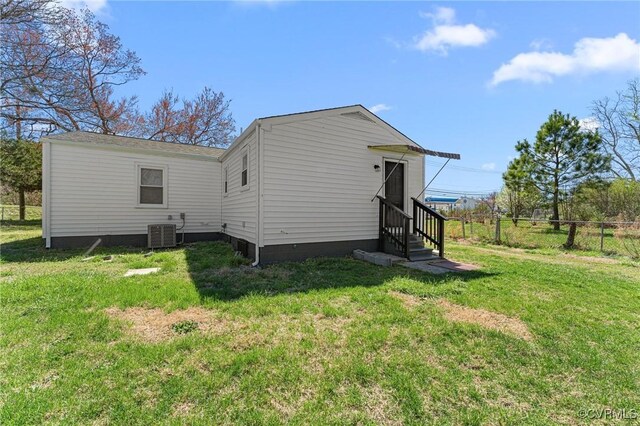 1713 Boydton Plank Rd, Petersburg, VA 23805 - rear view of property with a lawn, entry steps, fence, and central AC