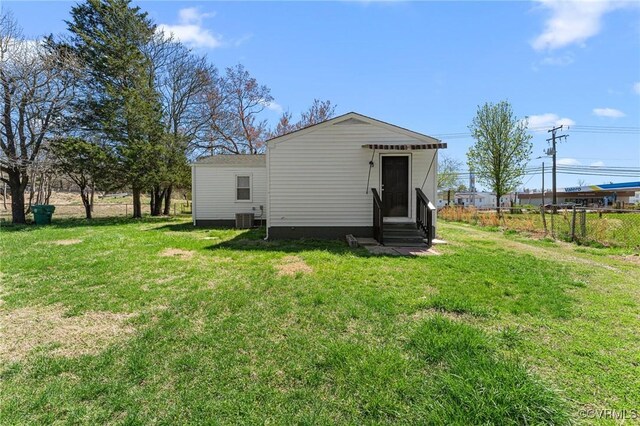 1713 Boydton Plank Rd, Petersburg, VA 23805 - back of property featuring a lawn, fence, central AC, and entry steps
